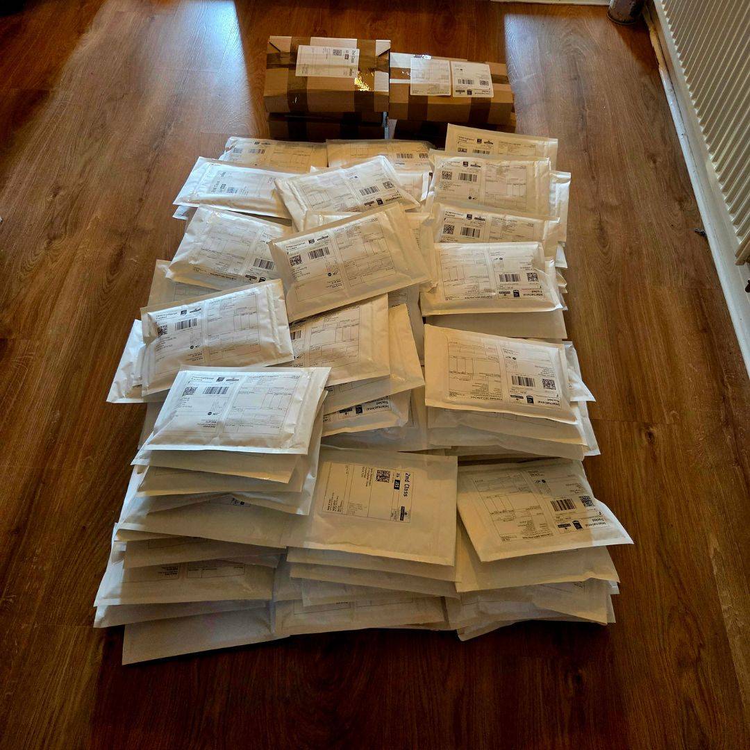 Numerous envelopes stuffed with The Chaos TTRPG